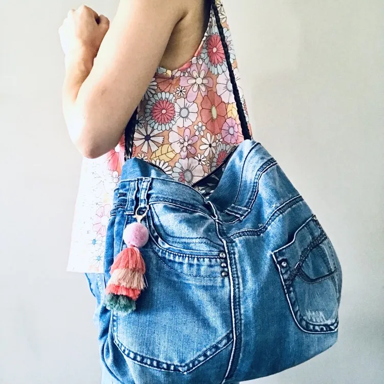 Upcycled denim hobo bag with retro floral print and braided strap